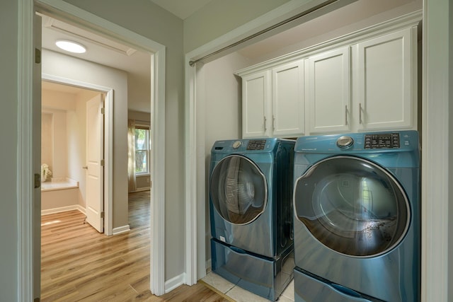 1899 Lamb Rd NW, Carroll, OH 43112 - laundry area with washing machine and clothes dryer, cabinet space, baseboards, and light wood finished floors