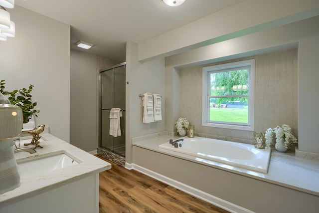 1899 Lamb Rd NW, Carroll, OH 43112 - full bathroom featuring wood finished floors, a shower stall, a bath, and baseboards