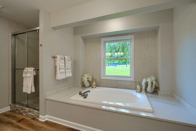 1899 Lamb Rd NW, Carroll, OH 43112 - bathroom with a shower stall, a bath, and wood finished floors
