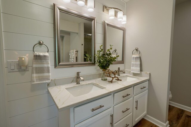 1899 Lamb Rd NW, Carroll, OH 43112 - bathroom with wood finished floors, double vanity, toilet, and baseboards