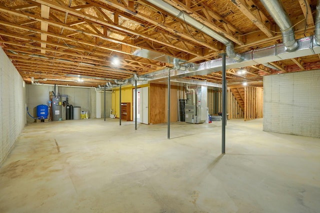 1899 Lamb Rd NW, Carroll, OH 43112 - unfinished basement with heating unit, electric water heater, a water pressure tank, and stairs