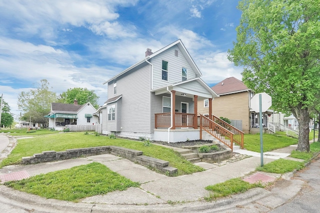 527 E Welch Ave, Columbus, OH 43207 - view of front of property with covered porch, a front lawn, and a chimney