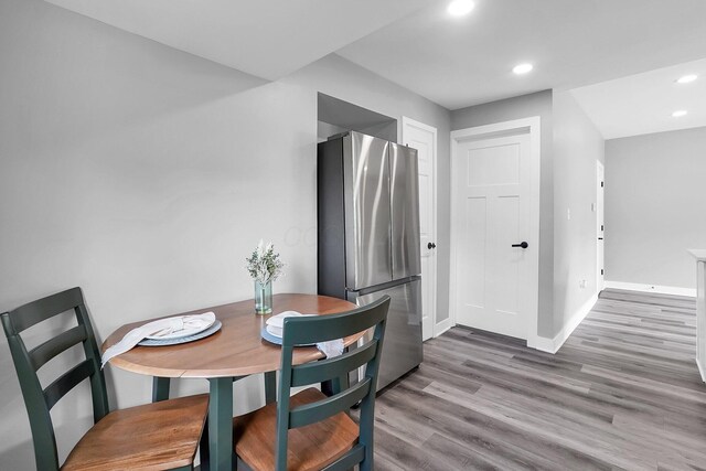 527 E Welch Ave, Columbus, OH 43207 - dining area with baseboards, wood finished floors, and recessed lighting