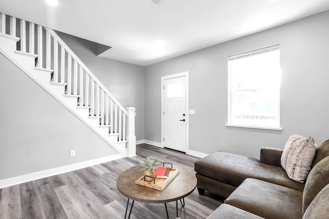 527 E Welch Ave, Columbus, OH 43207 - living room with stairway, wood finished floors, and baseboards