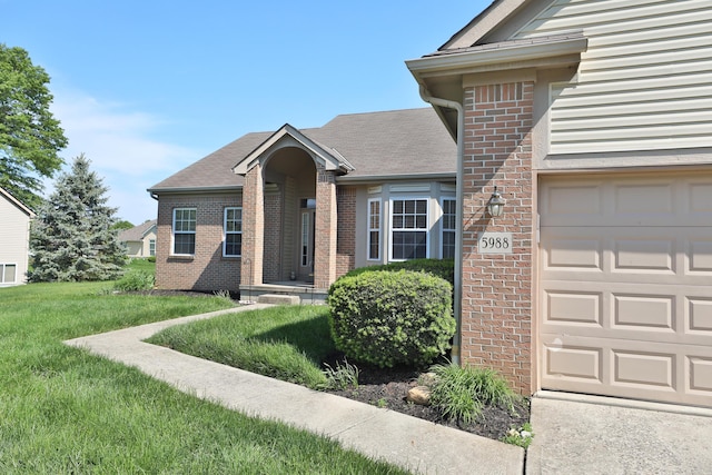 5988 Carnegie Cove Ct, Columbus, OH 43213 - view of front of property featuring brick siding and a front yard