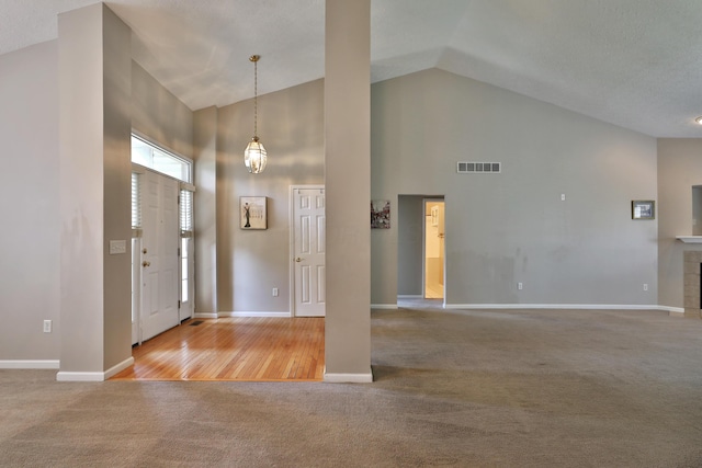5988 Carnegie Cove Ct, Columbus, OH 43213 - entryway with high vaulted ceiling, carpet floors, and baseboards