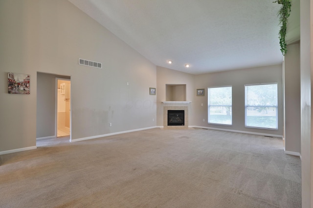 5988 Carnegie Cove Ct, Columbus, OH 43213 - unfurnished living room featuring carpet floors, baseboards, a tile fireplace, high vaulted ceiling, and recessed lighting