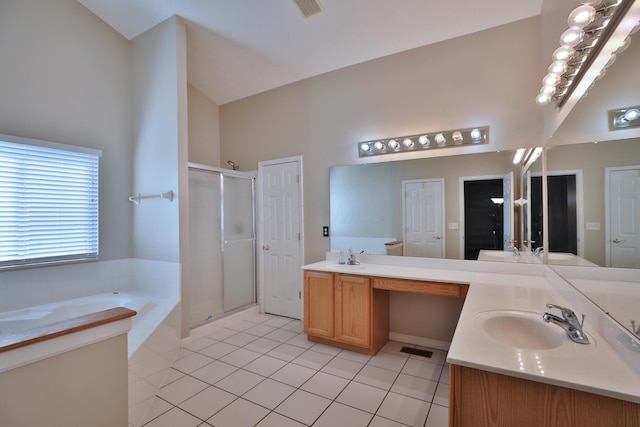 5988 Carnegie Cove Ct, Columbus, OH 43213 - bathroom with tile patterned flooring, a garden tub, a stall shower, double vanity, and high vaulted ceiling