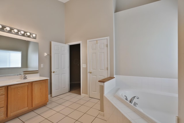 5988 Carnegie Cove Ct, Columbus, OH 43213 - bathroom with a towering ceiling, a garden tub, tile patterned flooring, and vanity