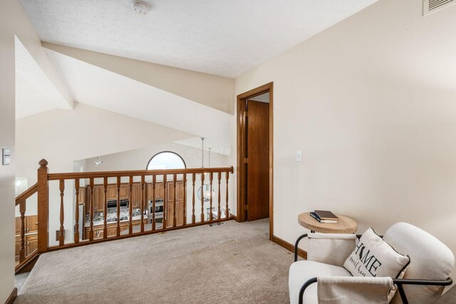living area featuring carpet floors, lofted ceiling, and baseboards