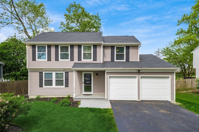 1279 Reana Dr, Galloway, OH 43119 - view of front of home featuring asphalt driveway, an attached garage, and a shingled roof