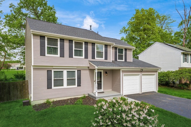 1279 Reana Dr, Galloway, OH 43119 - view of front of house featuring a garage, asphalt driveway, and roof with shingles