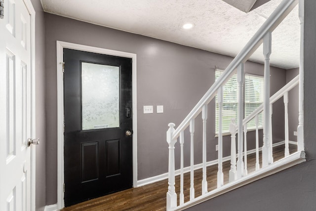 1279 Reana Dr, Galloway, OH 43119 - entryway with stairway, a textured ceiling, wood finished floors, and baseboards