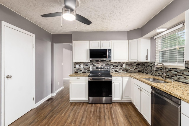 1279 Reana Dr, Galloway, OH 43119 - kitchen with stainless steel appliances, a sink, dark wood-type flooring, tasteful backsplash, and white cabinets
