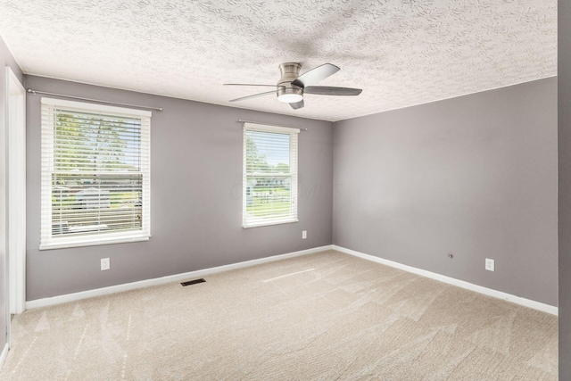 1279 Reana Dr, Galloway, OH 43119 - unfurnished room featuring a ceiling fan, baseboards, light colored carpet, and a textured ceiling