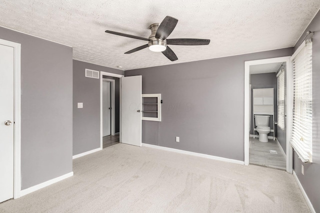 1279 Reana Dr, Galloway, OH 43119 - unfurnished bedroom featuring carpet, baseboards, a textured ceiling, ensuite bath, and a ceiling fan