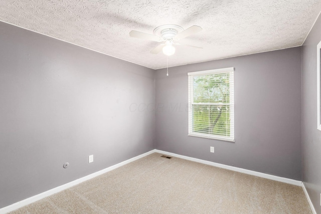 1279 Reana Dr, Galloway, OH 43119 - empty room with light carpet, ceiling fan, baseboards, and a textured ceiling