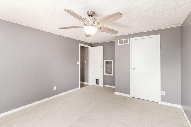 1279 Reana Dr, Galloway, OH 43119 - unfurnished bedroom featuring baseboards, light colored carpet, a textured ceiling, and a ceiling fan