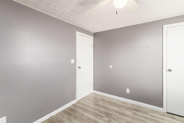 1279 Reana Dr, Galloway, OH 43119 - spare room with ceiling fan, light wood finished floors, a textured ceiling, and baseboards