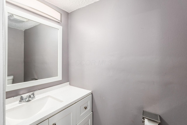 1279 Reana Dr, Galloway, OH 43119 - half bath with vanity, a textured ceiling, and toilet