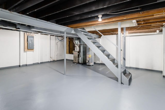 1279 Reana Dr, Galloway, OH 43119 - basement featuring electric panel, stairway, water heater, heating unit, and concrete block wall