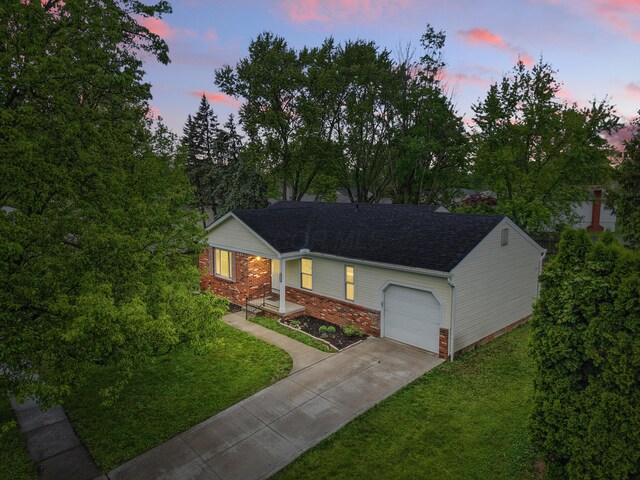 4726 Wendler Blvd, Columbus, OH 43230 - view of front of house with a garage, concrete driveway, a lawn, and roof with shingles