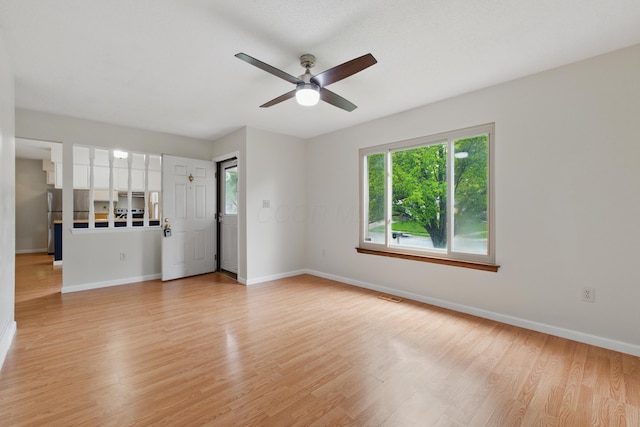 4726 Wendler Blvd, Columbus, OH 43230 - unfurnished living room featuring ceiling fan, baseboards, and light wood-style flooring