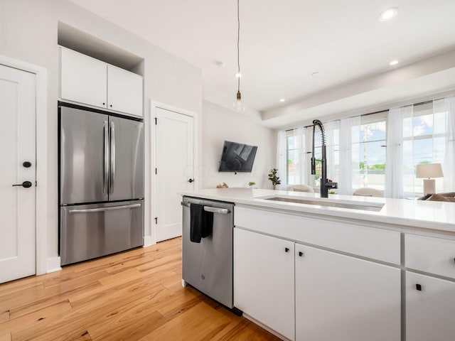 201 E 5th Ave, Columbus, OH 43201 - kitchen with stainless steel appliances, a sink, light wood finished floors, light countertops, and recessed lighting
