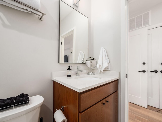 201 E 5th Ave, Columbus, OH 43201 - bathroom featuring vanity, wood finished floors, and toilet