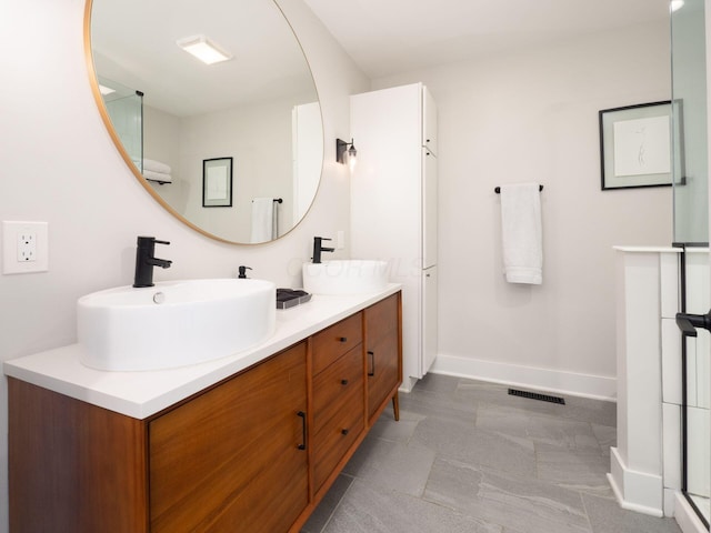 201 E 5th Ave, Columbus, OH 43201 - bathroom featuring baseboards, double vanity, and a shower