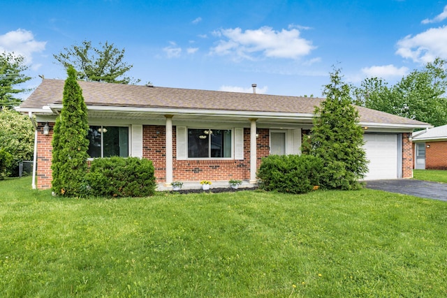 717 Birmingham Rd, Westerville, OH 43081 - ranch-style home featuring asphalt driveway, an attached garage, brick siding, and a front yard