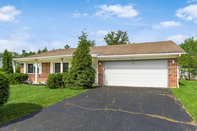 717 Birmingham Rd, Westerville, OH 43081 - view of front of house featuring asphalt driveway, an attached garage, brick siding, and a front yard