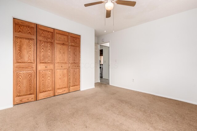 717 Birmingham Rd, Westerville, OH 43081 - unfurnished bedroom with light colored carpet, baseboards, a ceiling fan, and a closet