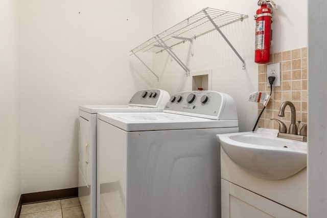 717 Birmingham Rd, Westerville, OH 43081 - clothes washing area featuring independent washer and dryer, light tile patterned flooring, and baseboards