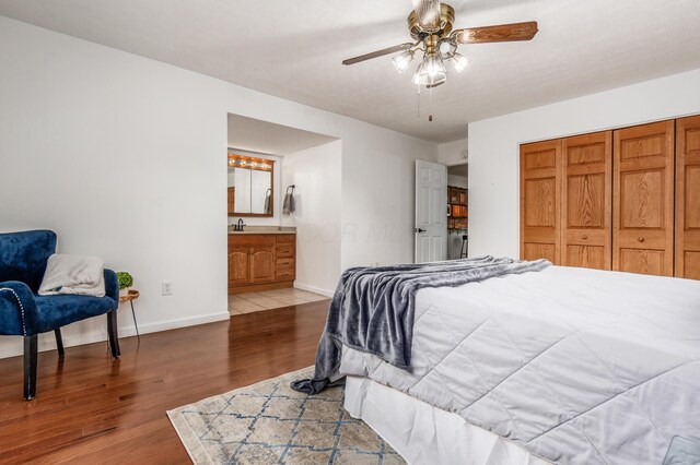 717 Birmingham Rd, Westerville, OH 43081 - bedroom with wood finished floors, baseboards, a sink, connected bathroom, and a closet