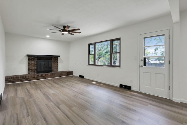 1883 Fairhaven Rd, Columbus, OH 43229 - unfurnished living room featuring a ceiling fan, healthy amount of natural light, wood finished floors, a fireplace, and recessed lighting