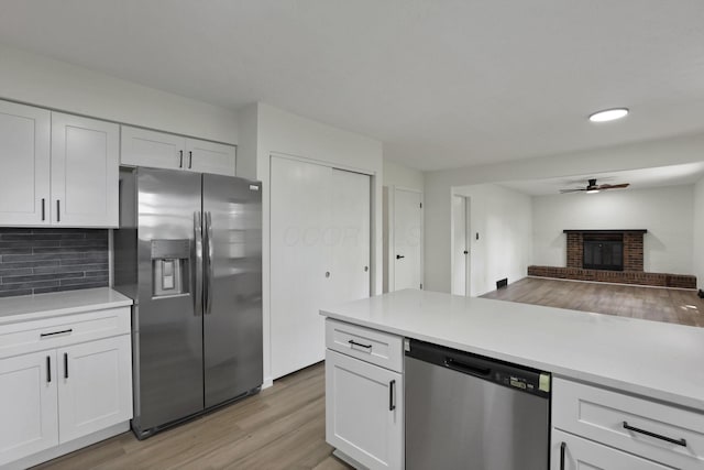 1883 Fairhaven Rd, Columbus, OH 43229 - kitchen featuring stainless steel appliances, a ceiling fan, light wood-style floors, white cabinets, and recessed lighting
