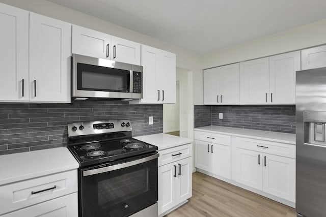1883 Fairhaven Rd, Columbus, OH 43229 - kitchen featuring stainless steel appliances, light countertops, white cabinets, and decorative backsplash