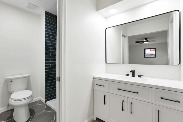 1883 Fairhaven Rd, Columbus, OH 43229 - bathroom featuring vanity, toilet, tiled shower, a ceiling fan, and baseboards
