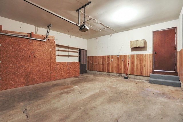 1883 Fairhaven Rd, Columbus, OH 43229 - garage featuring a garage door opener, wainscoting, and wooden walls