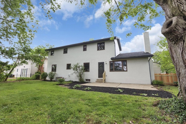 1883 Fairhaven Rd, Columbus, OH 43229 - rear view of house featuring entry steps, a chimney, a patio, and stucco siding