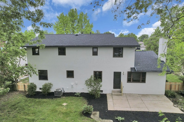 1883 Fairhaven Rd, Columbus, OH 43229 - back of property with central air condition unit, a shingled roof, a patio area, and stucco siding