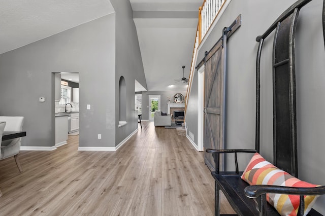 4008 Ryleland Ct, Powell, OH 43065 - entryway featuring a fireplace, light wood finished floors, high vaulted ceiling, ceiling fan, and baseboards