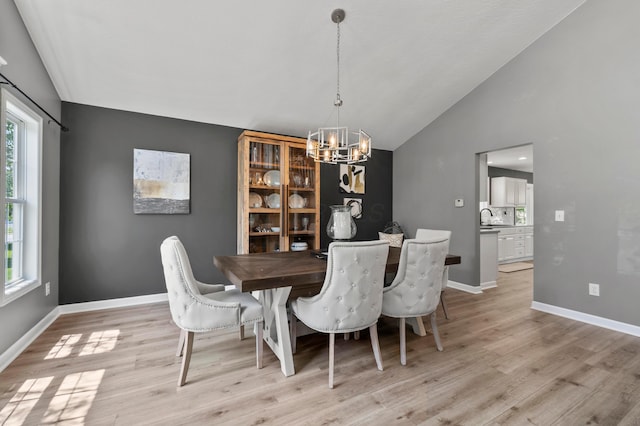 4008 Ryleland Ct, Powell, OH 43065 - dining room featuring lofted ceiling, a chandelier, light wood finished floors, and baseboards