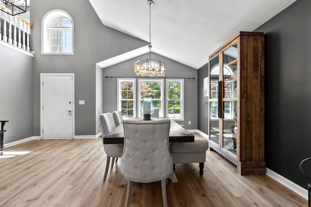 4008 Ryleland Ct, Powell, OH 43065 - dining space with a chandelier, vaulted ceiling, light wood-style floors, and baseboards