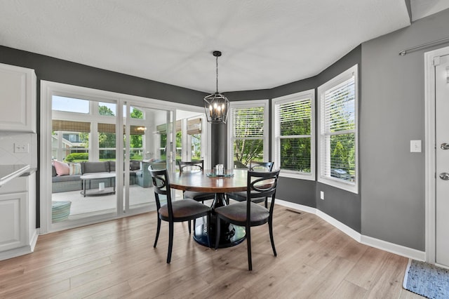 4008 Ryleland Ct, Powell, OH 43065 - dining area featuring a chandelier, light wood-type flooring, and baseboards