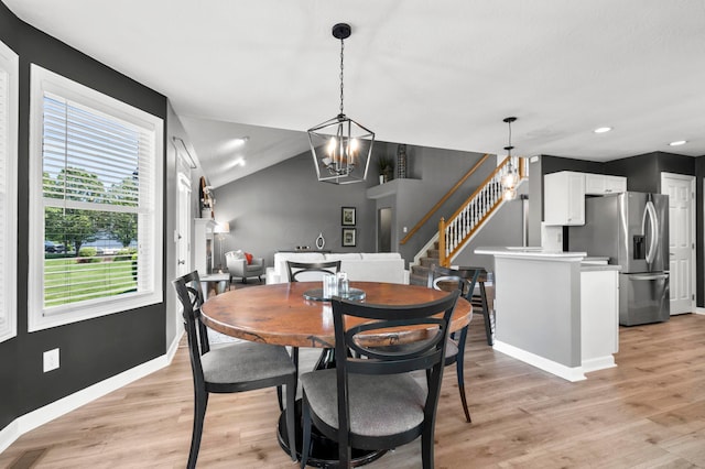 4008 Ryleland Ct, Powell, OH 43065 - dining room featuring stairs, a chandelier, baseboards, light wood finished floors, and vaulted ceiling