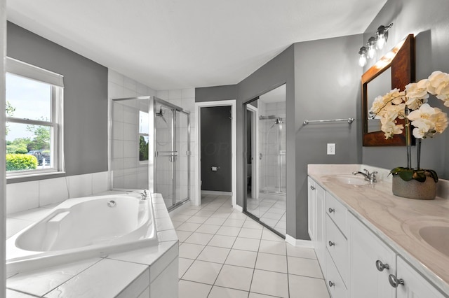 4008 Ryleland Ct, Powell, OH 43065 - bathroom featuring a shower stall, a garden tub, double vanity, tile patterned flooring, and baseboards