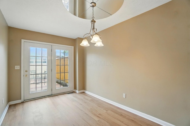 662 Pamlico St Unit Z7, Columbus, OH 43228 - unfurnished dining area with light wood-type flooring, baseboards, and a chandelier
