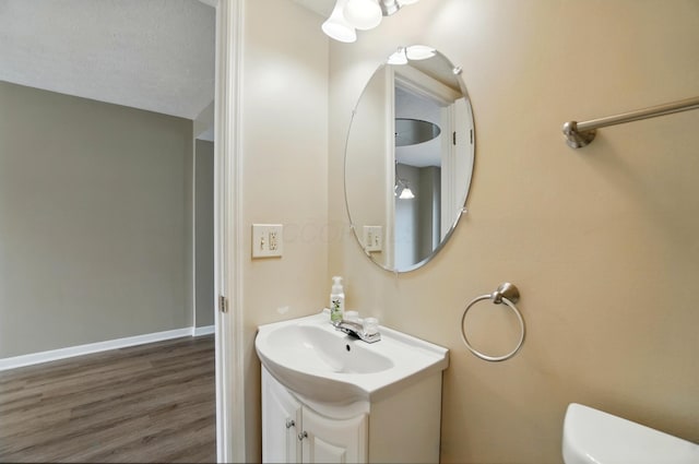 662 Pamlico St Unit Z7, Columbus, OH 43228 - bathroom featuring toilet, wood finished floors, vanity, and baseboards